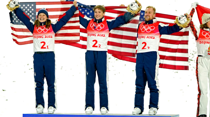Ashley Caldwell, Christopher Lillis and Justin Schoenefeld  celebrate winning the gold medal in the Mixed Freestyle Skiing Aerials Team Final during the Beijing 2022 Olympic Winter Games.